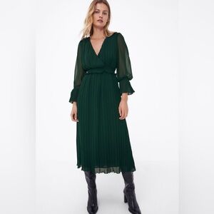 Deep green pleated chiffon dress with flowy sleeves